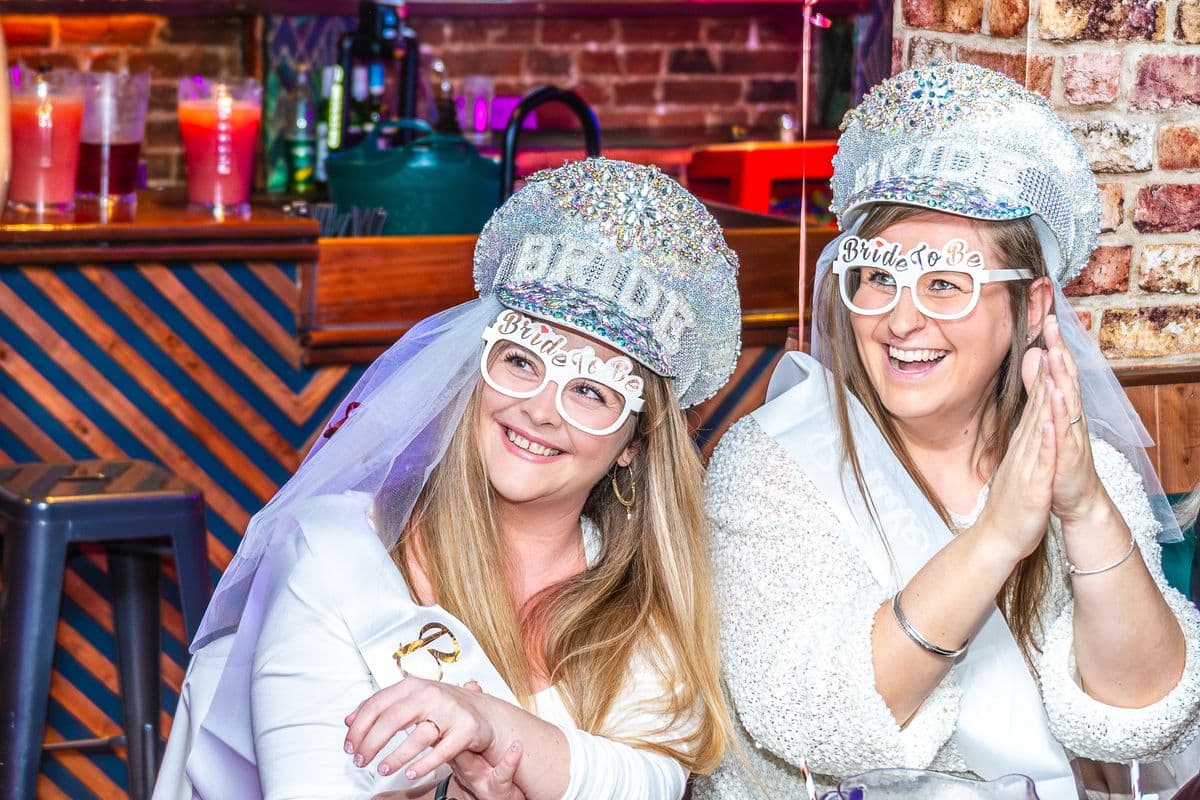 Two brides-to-be in sparkly BRIDE caps