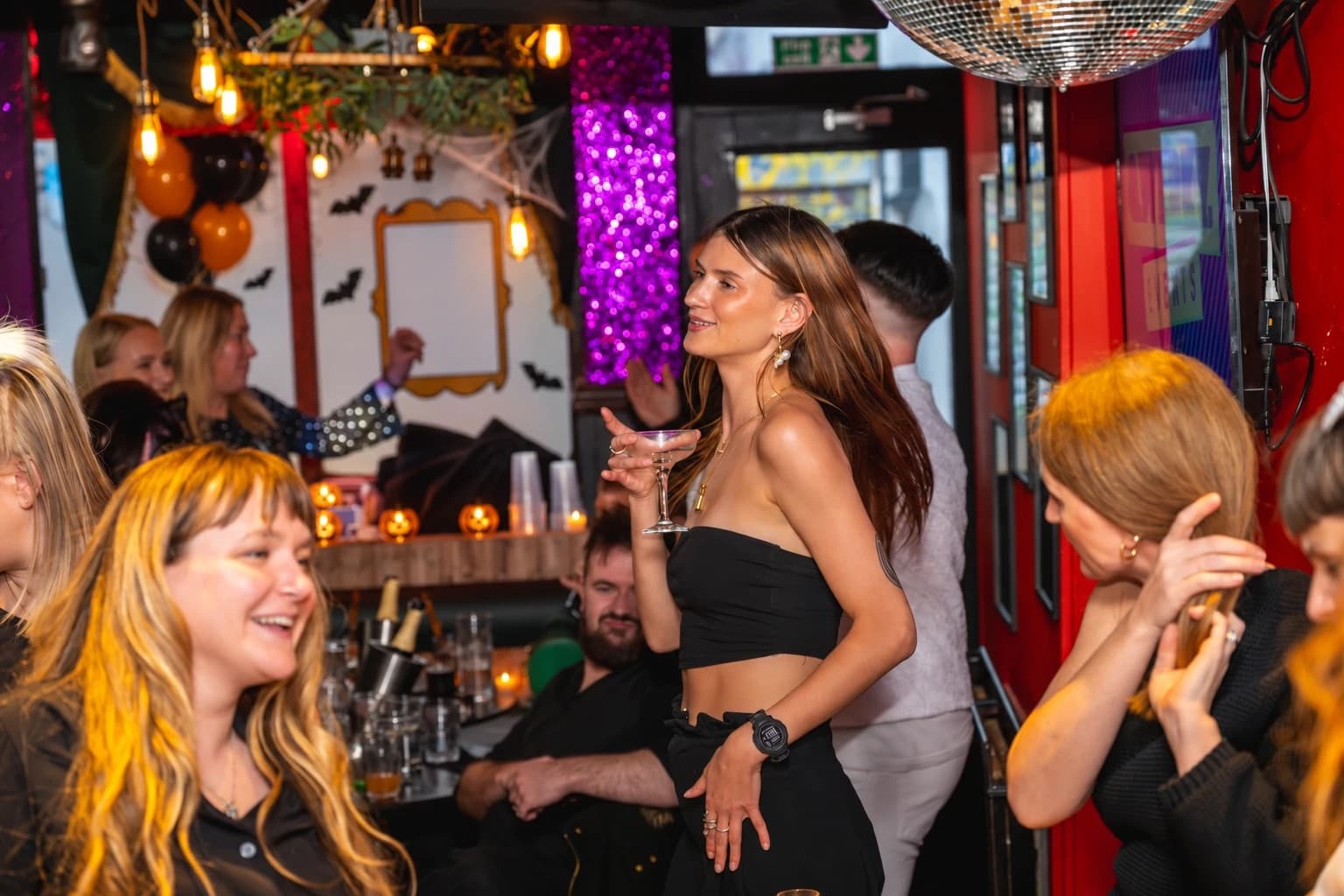 A guest dancing with a cocktail