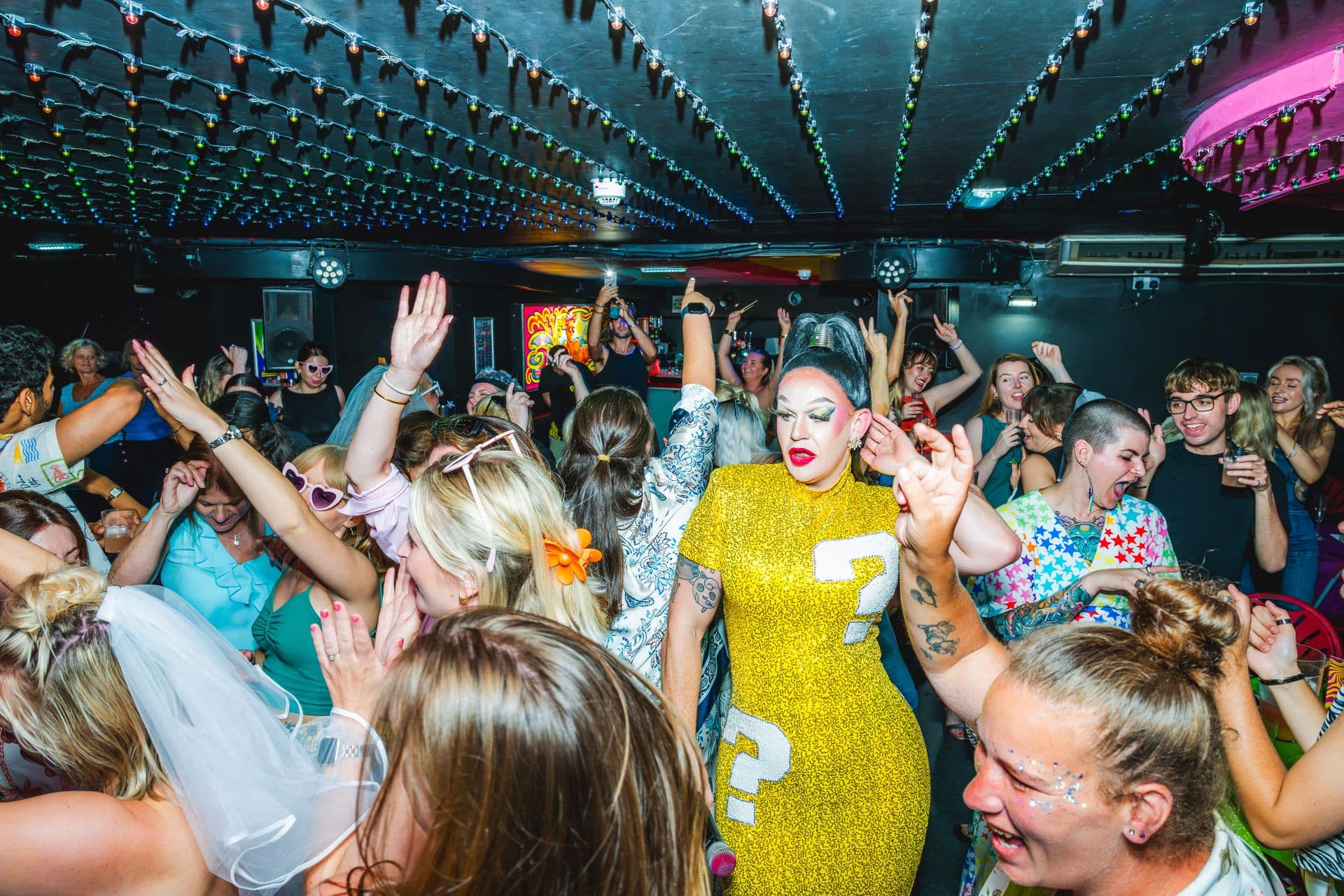 A Qwerky drag queen dancing with a packed room at Legends Brighton