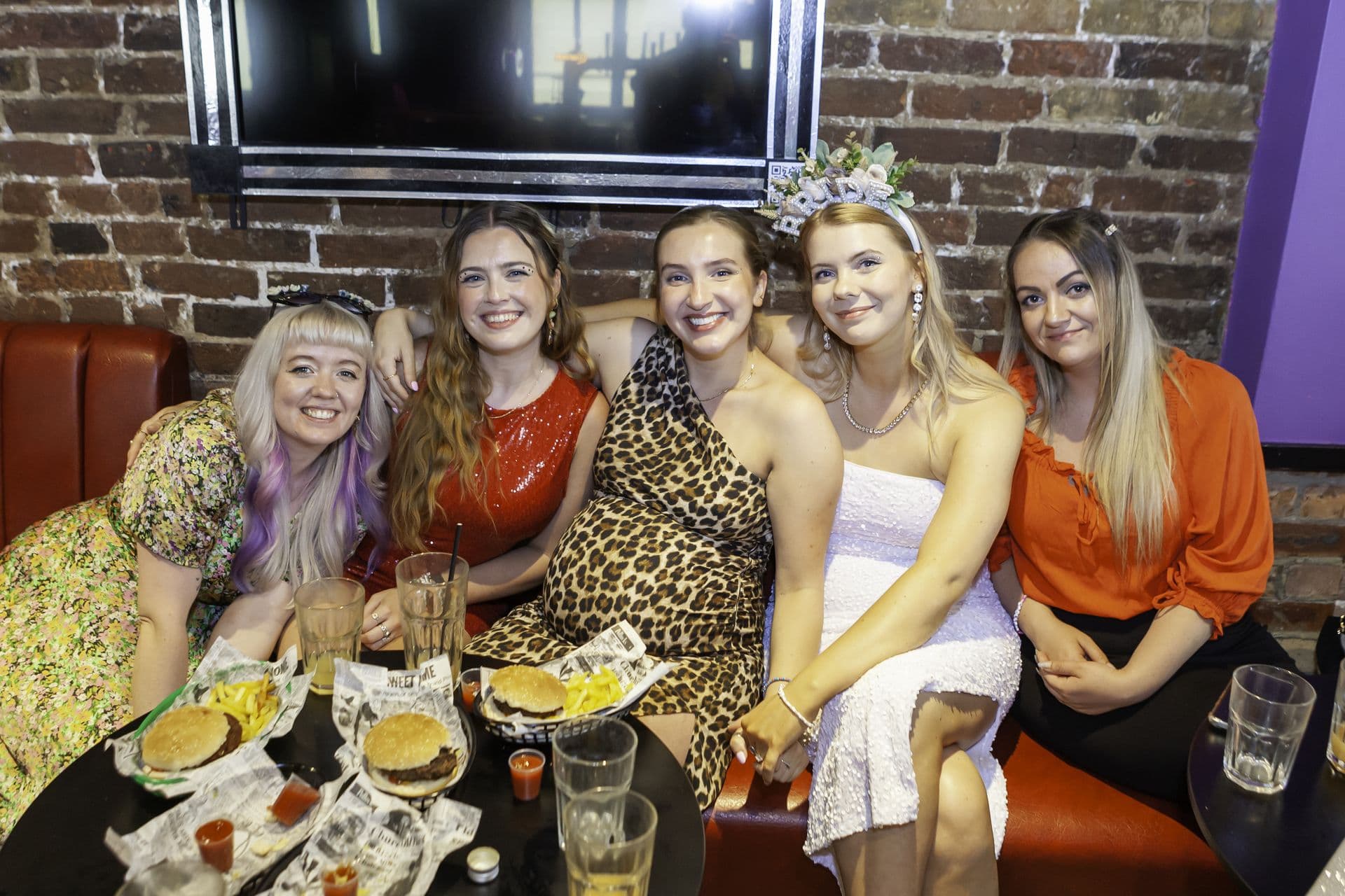 A group of colleagues at a brunch table at a Qwerky drag brunch