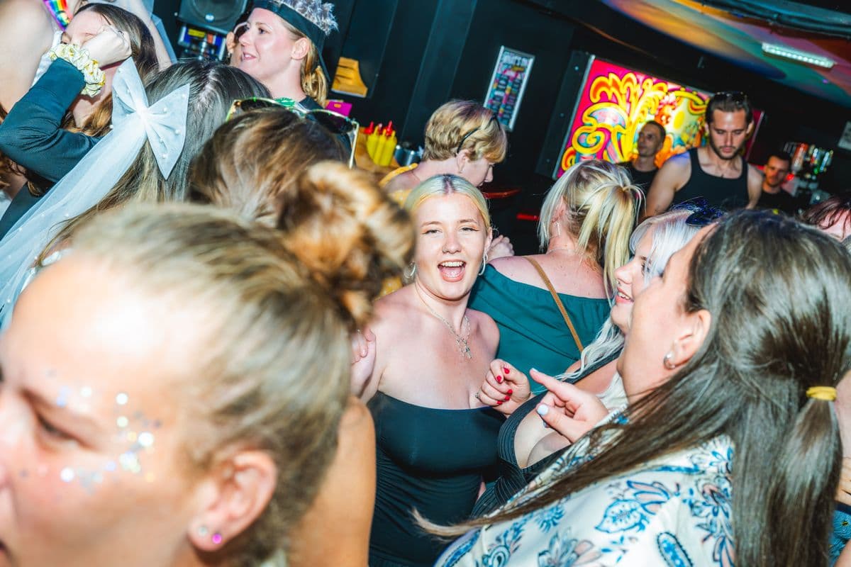 Guests with glitter faces dancing together
